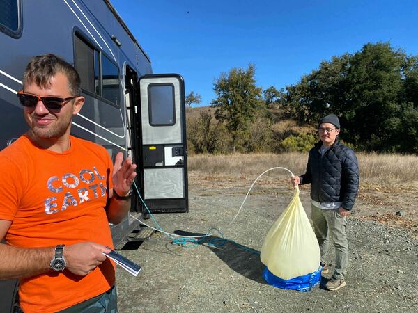 Iseman and Song prepare a balloon with sulfur dioxide and helium.