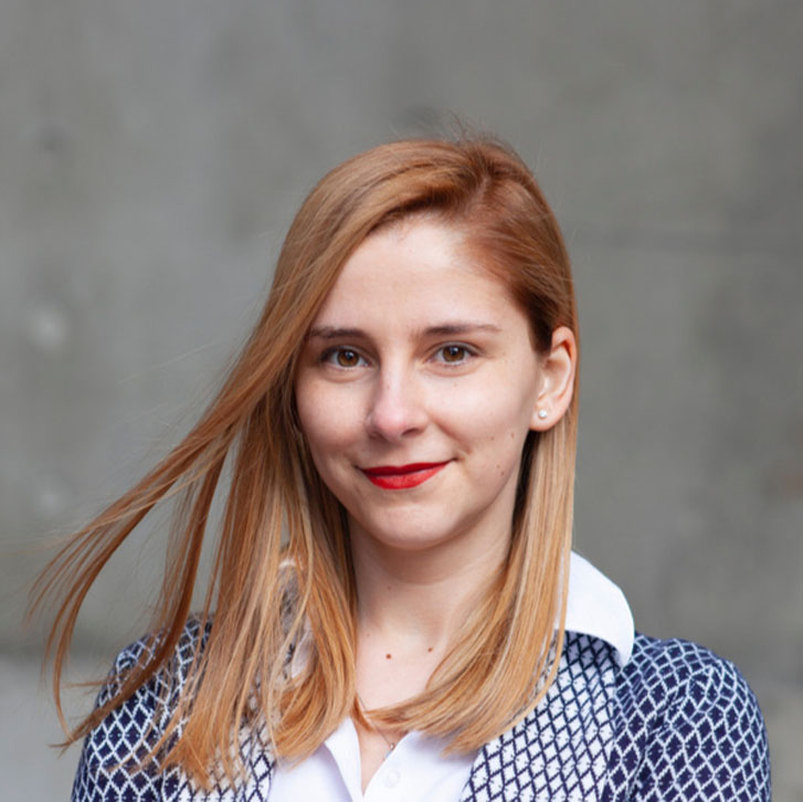 headshot of startups woman smiling in red lipstick anc professional clothes